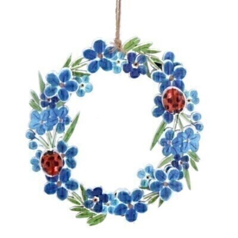 A blue and red wooden wreath hanging decoration featuring forget-me-nots and ladybirds. Made by London based designer Gisela Graham who designs really beautiful gifts for your home and garden.  Would suit any home decor and would make a lovely gift. Matching items available. 